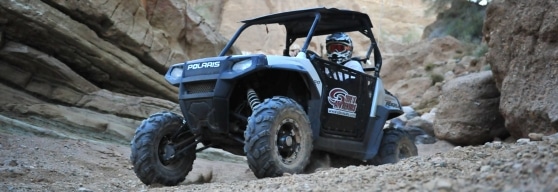 Guest riding an ATV through rocky areas