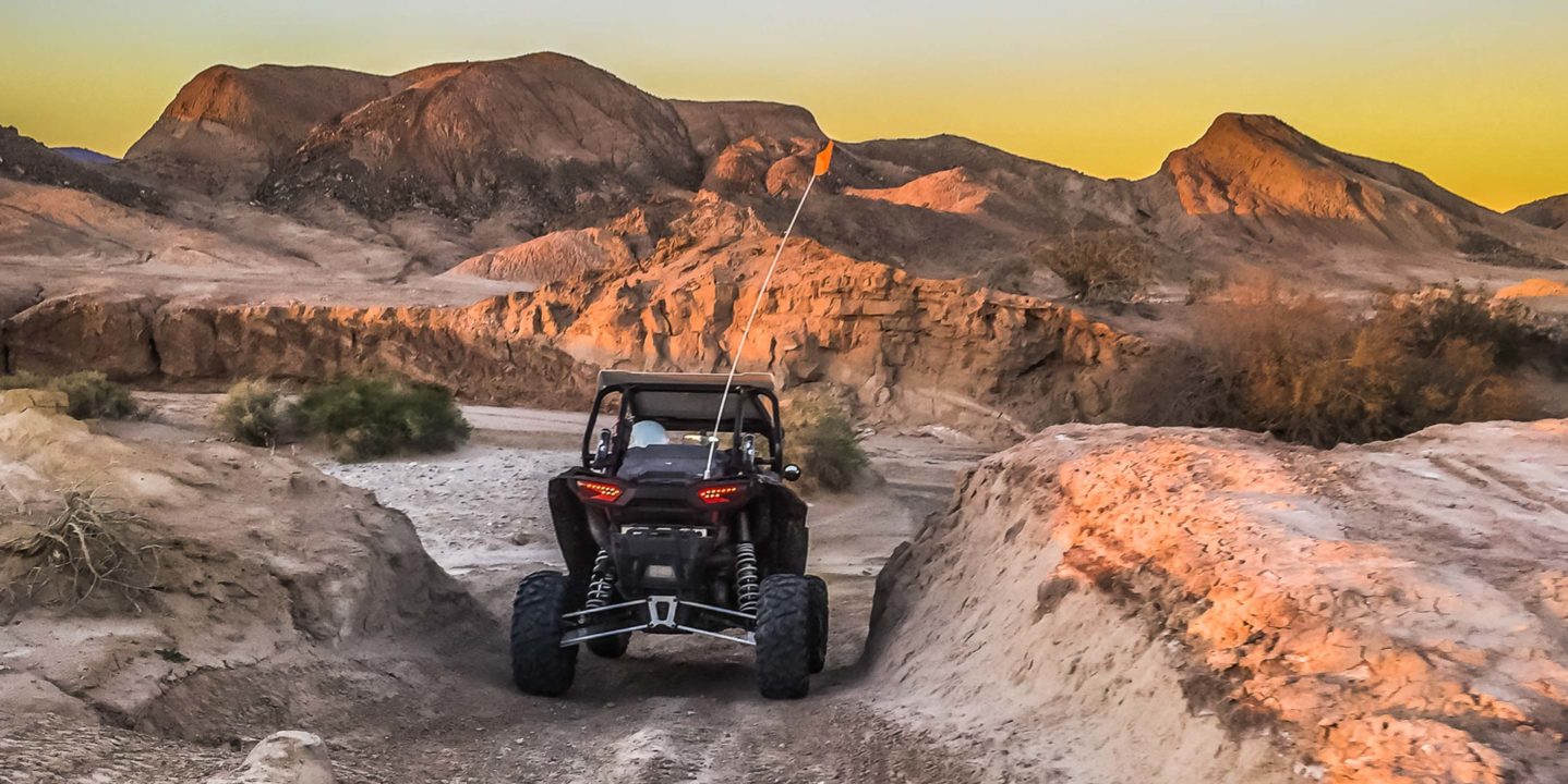 Guest riding ATV in rocky terrain