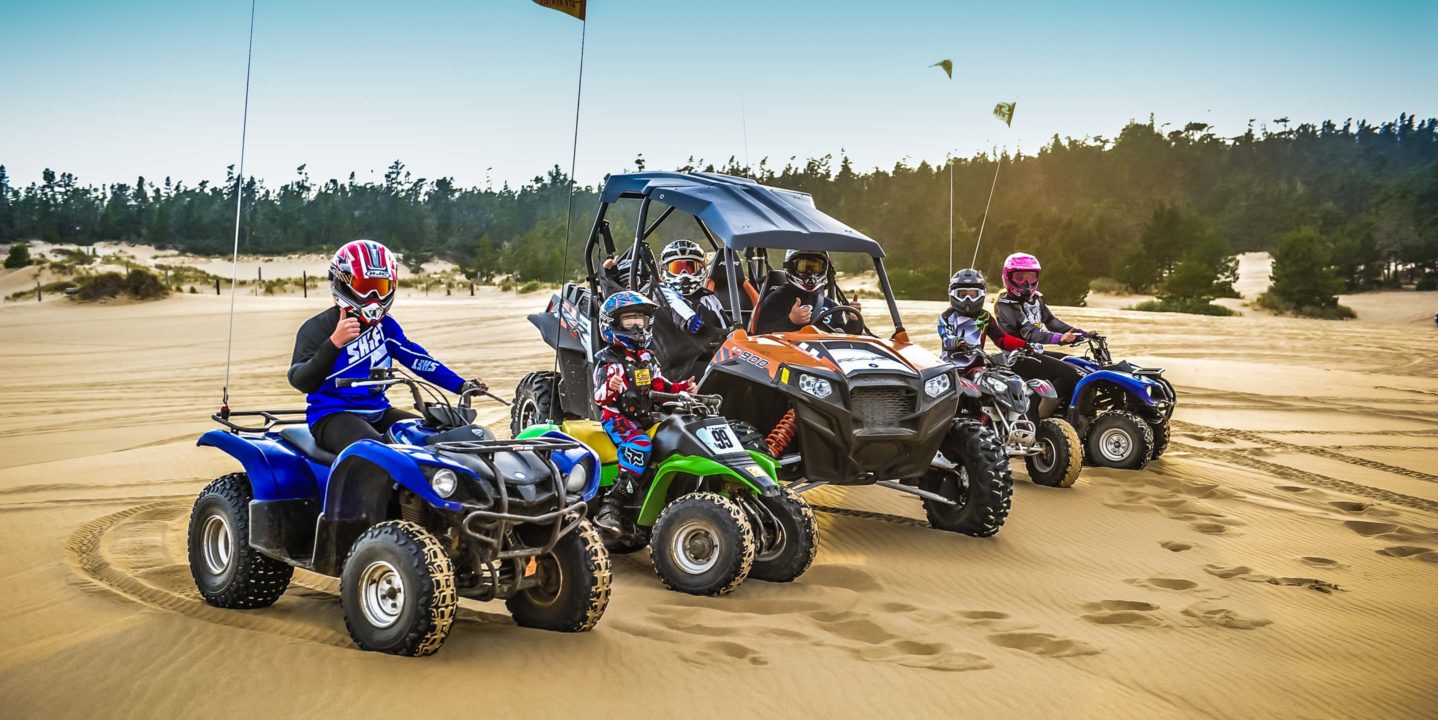 Children and adults riding ATVs