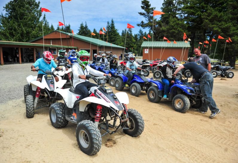 Group of guests sitting on ATV in Oregon, ready to ride