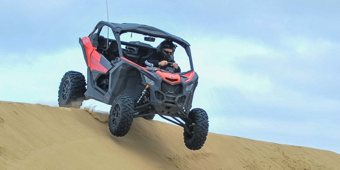 Guest riding an ATV down a sand dune at Pismo Beach