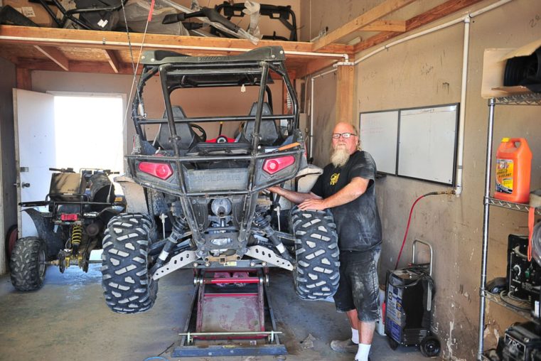 Staff fixing an ATV at the Salton City Offroad service and parts center