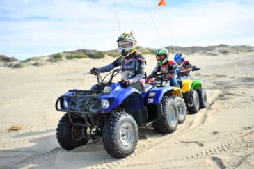 Family riding on colorful ATVs