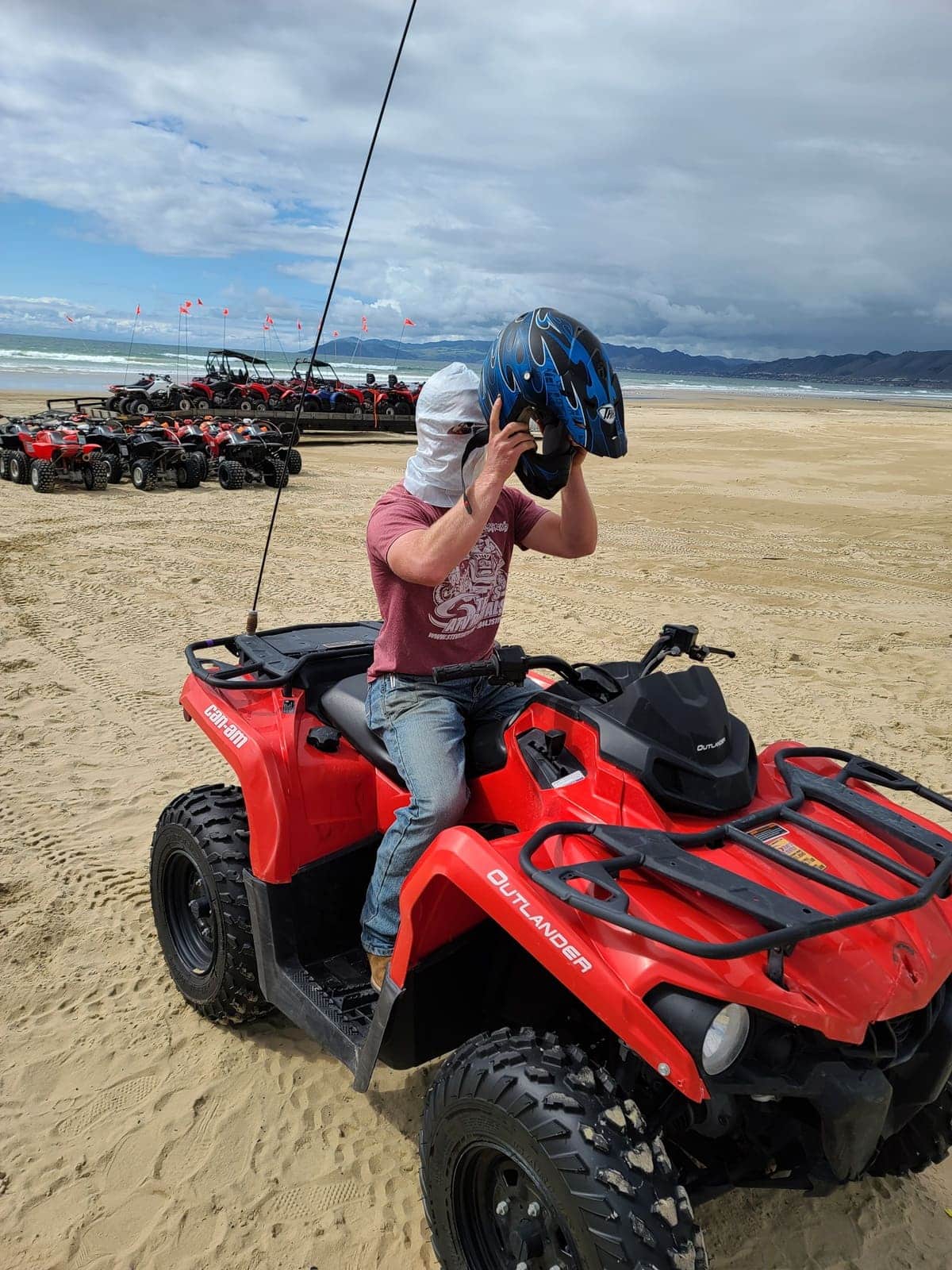 Guest on ATV taking off his helmet